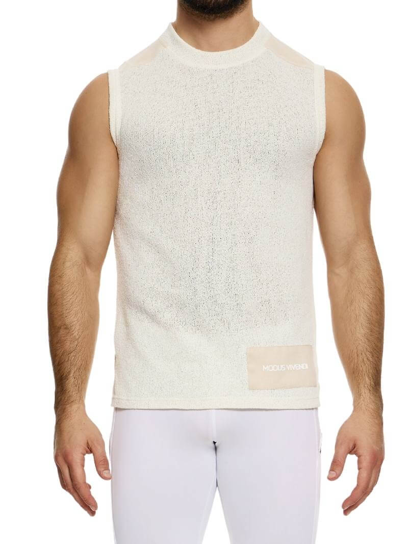 A male model wearing a white plain knit vest with a semi-turtle neck and long length.