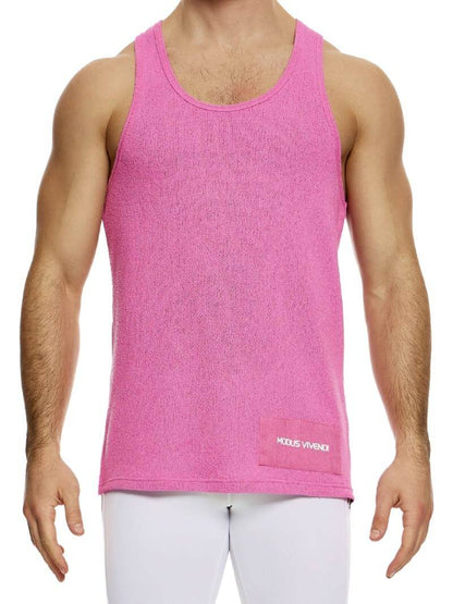 A male model wearing a long-length, round scoop neck, racer back, and straight fit pink knitted tank top with a linen panel on the back.