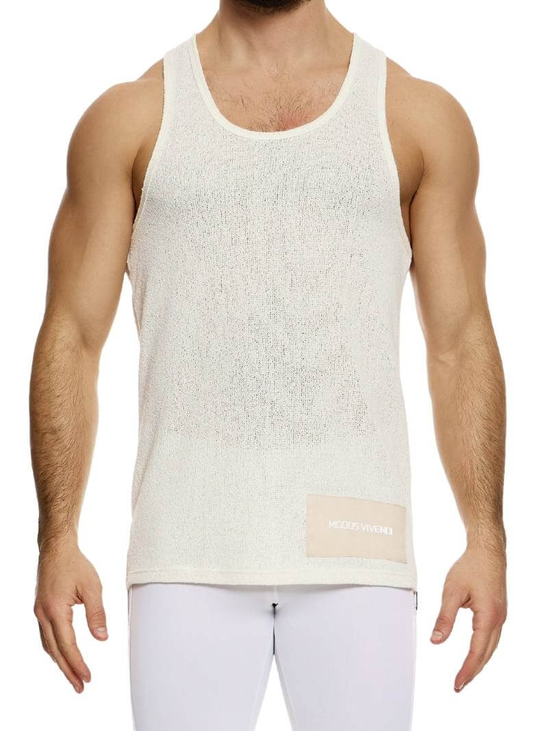 A male model wearing a long-length, round scoop neck, racer back, and straight fit pink knitted tank top with a linen panel on the back.