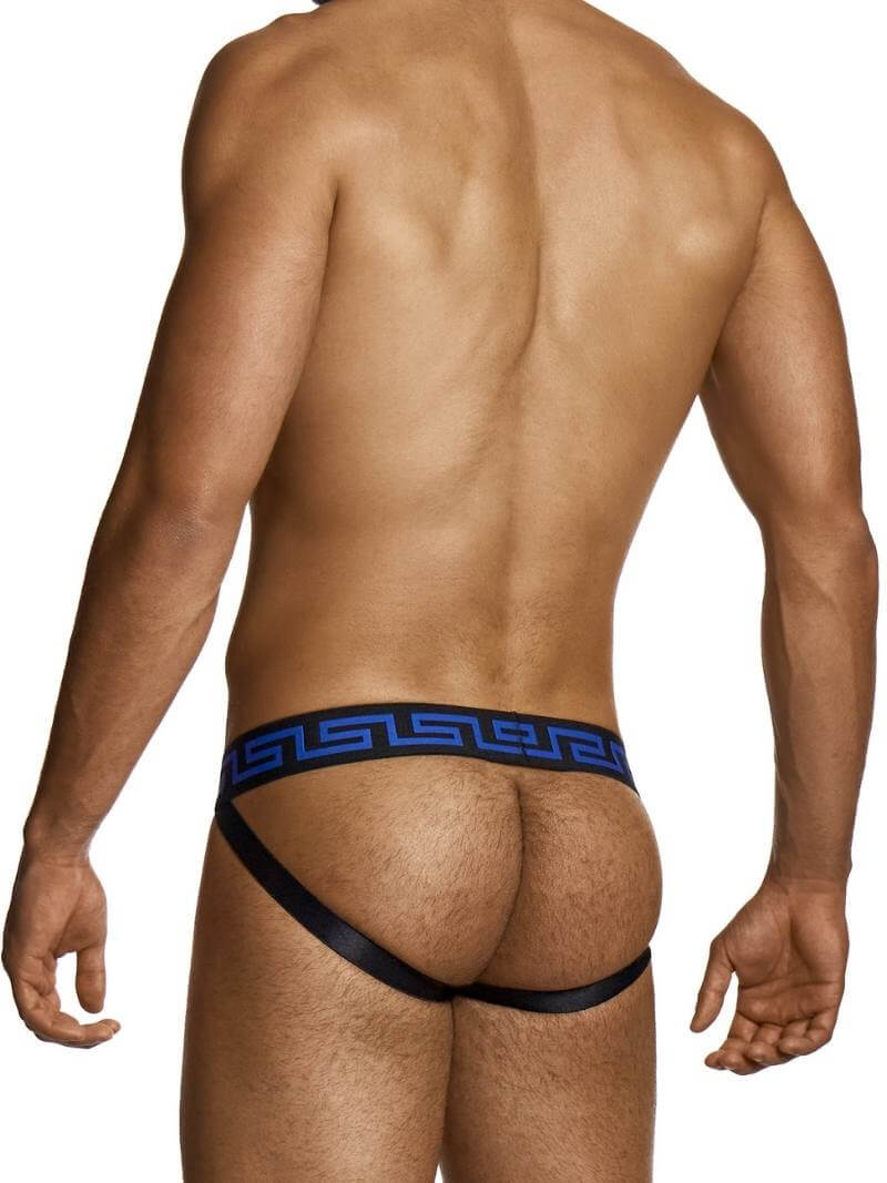Man wearing a black thong with blue waistband on a white background