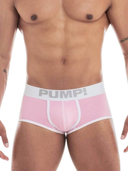 A model wearing a PUMP Underwear Milkshake Cotton Access Backless Trunk in a pastel color with white stitching and trims. The underwear is low-rise with a wide elasticated waistband featuring PUMP! branding.