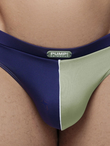 Close-up of a person wearing blue and green swimwear with 'Pump!' branding.