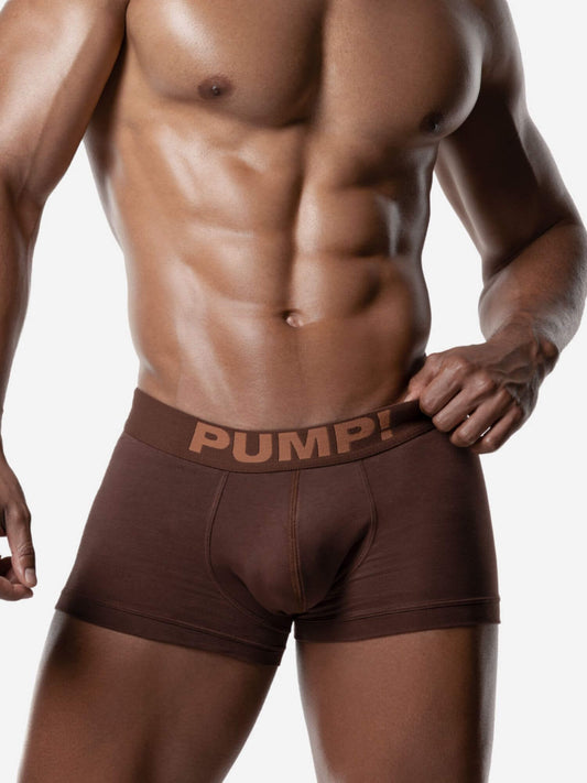 Man wearing brown boxer briefs with 'PUMP!' branding on a white background