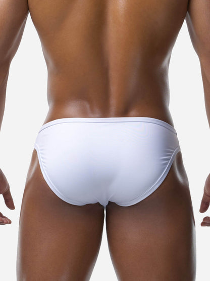 White men's swimwear brief on a person against a white background