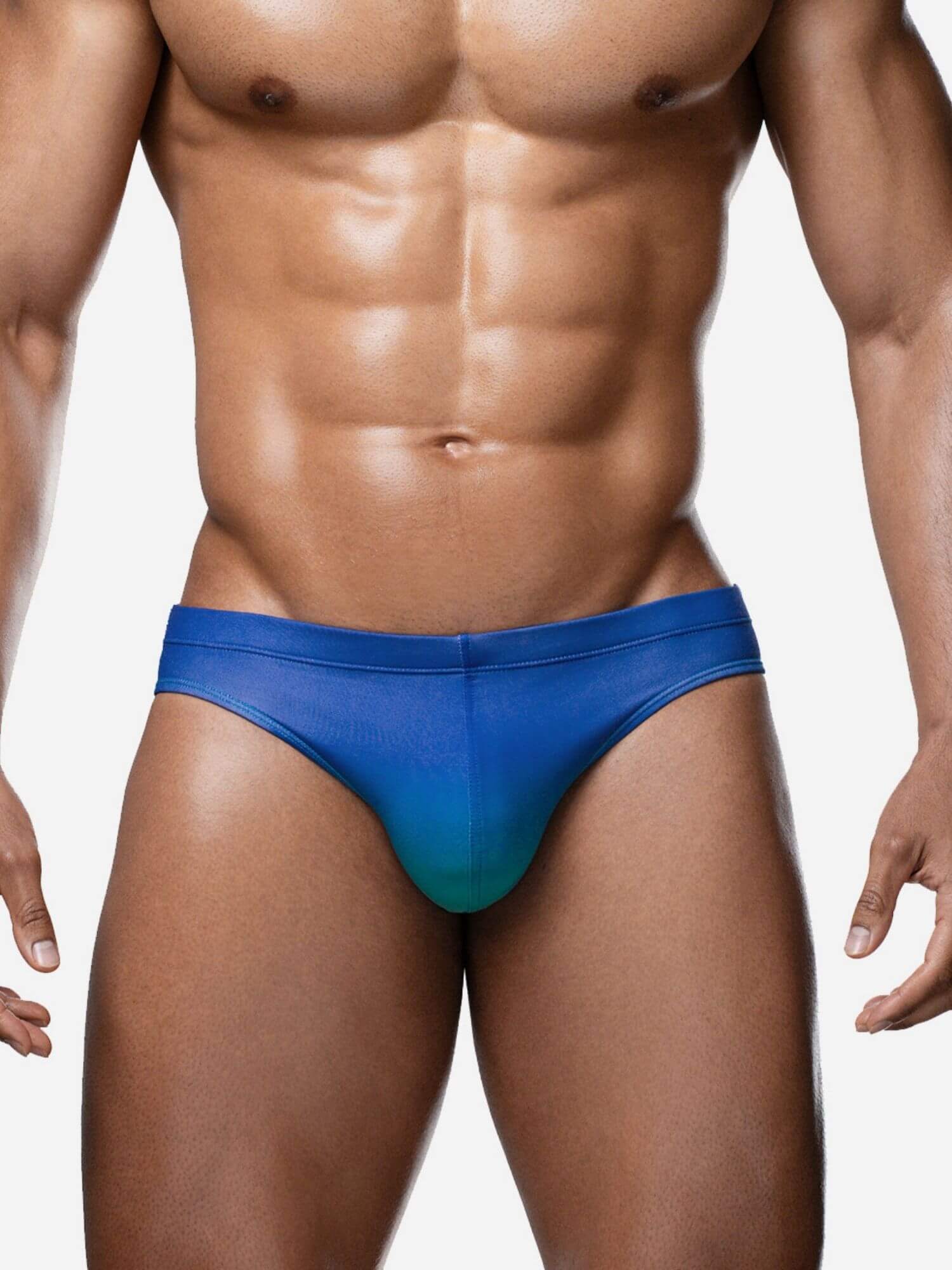 Man wearing a blue swim brief on a plain background