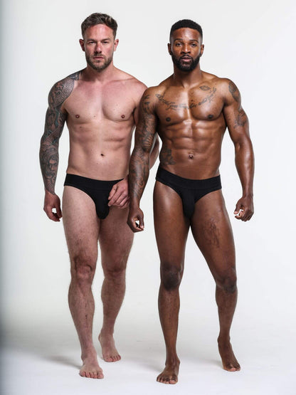 Two men wearing black underwear against a white background