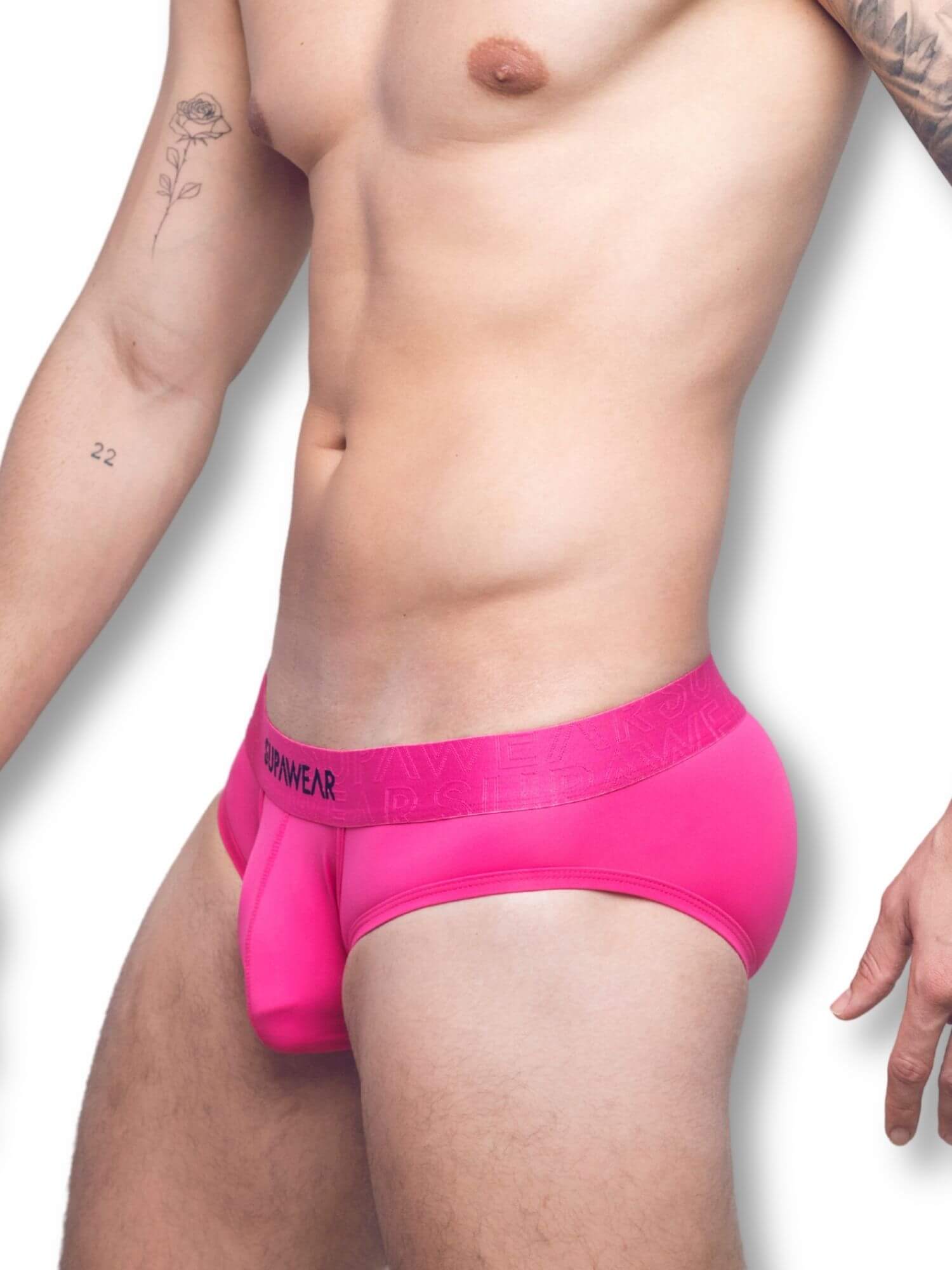 Person wearing bright pink underwear on a white background