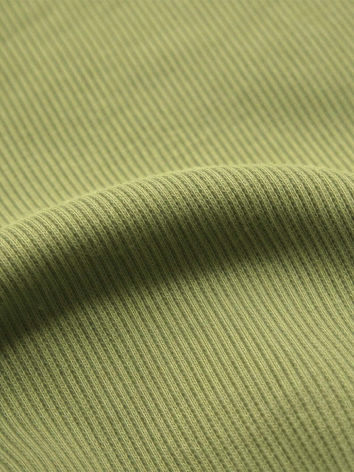 Close-up of green ribbed fabric texture