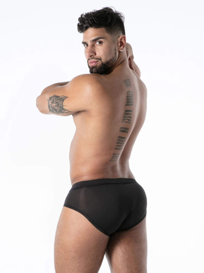 Man wearing black underwear with a white background