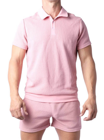 Close-up of a pink checkered garment with a focus on texture and pattern.