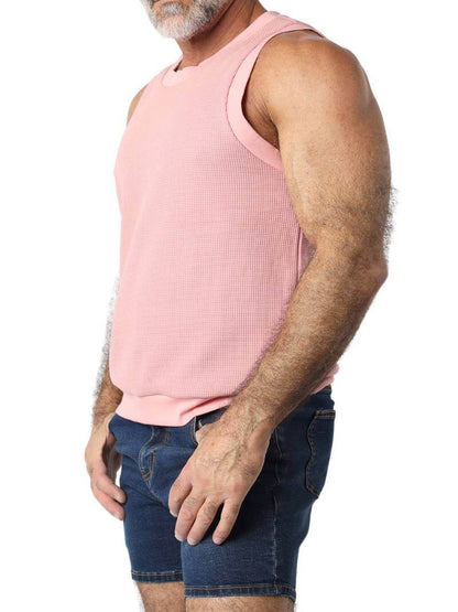 Close-up of a person wearing a pink sleeveless shirt on a white background