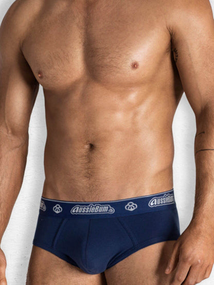 Man wearing navy blue underwear with 'AussieBum' branding on a white background