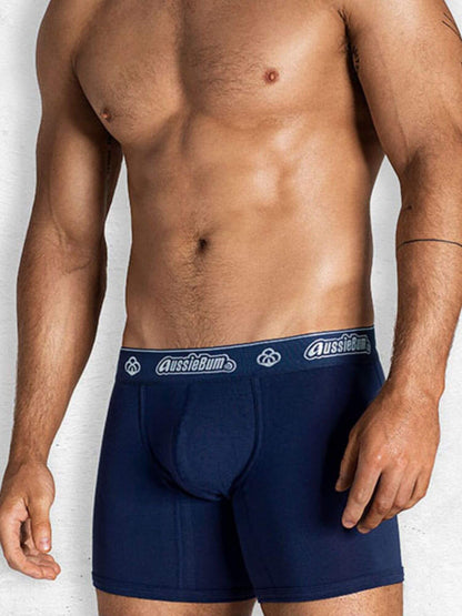 Man wearing navy blue underwear with 'AussieBum' branding on a white background