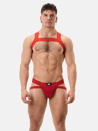 Man wearing a red chest harness against a white background