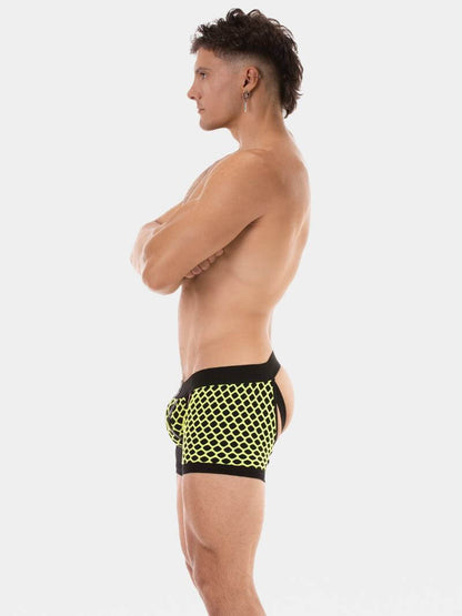 Man wearing black and yellow swim shorts on a white background