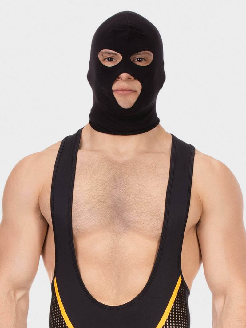 Person wearing a black balaclava and black athletic outfit with yellow trim on a white background