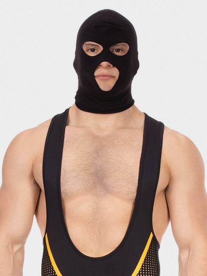 Person wearing a black balaclava and black athletic outfit with yellow trim on a white background