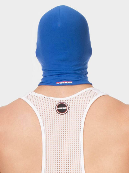 Person wearing a blue hooded garment with visible branding on a white background