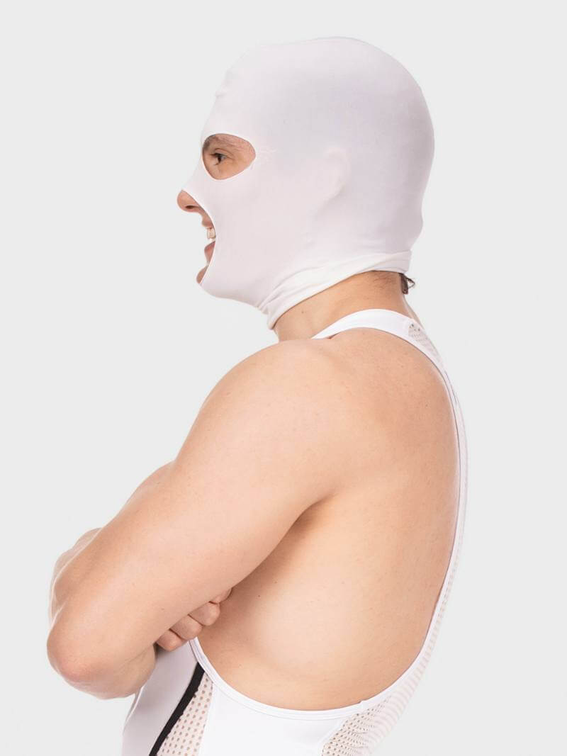 Person wearing a white balaclava and white tank top on a light gray background
