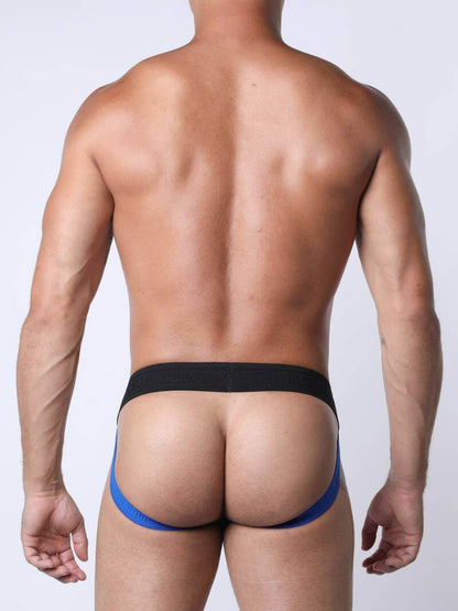 Man wearing a black and blue thong against a plain background