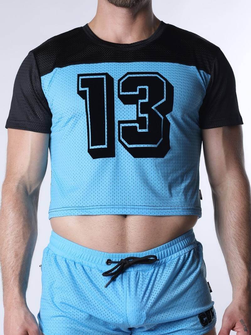 Person wearing a blue athletic outfit with the number 13 on a white background