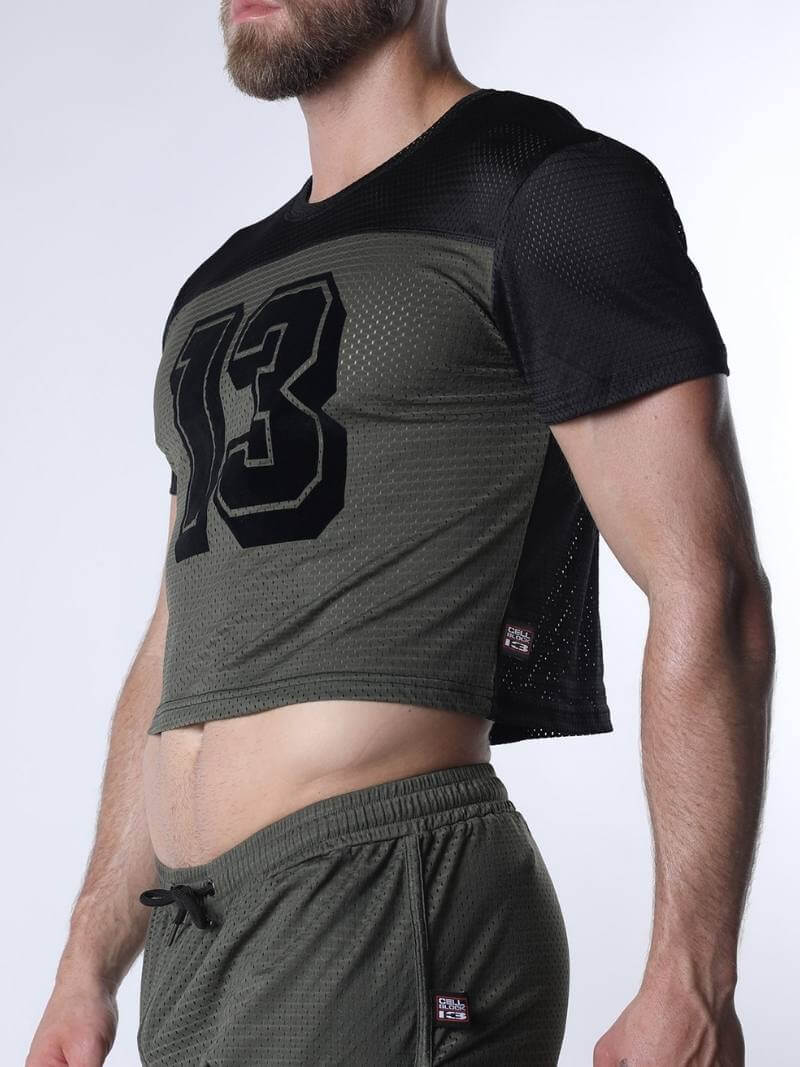 Person wearing a black and green athletic outfit with the number 13 on a white background