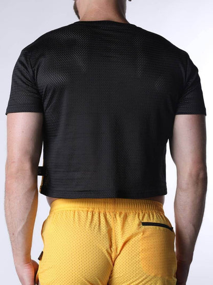 Person wearing a black athletic shirt and yellow shorts on a white background