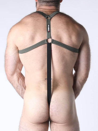 Man wearing a mesh harness with a plain background