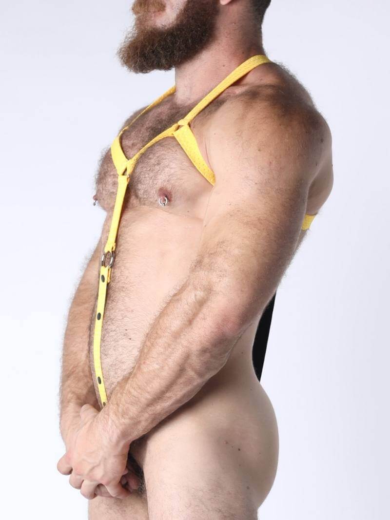 Man wearing a yellow thong against a white background