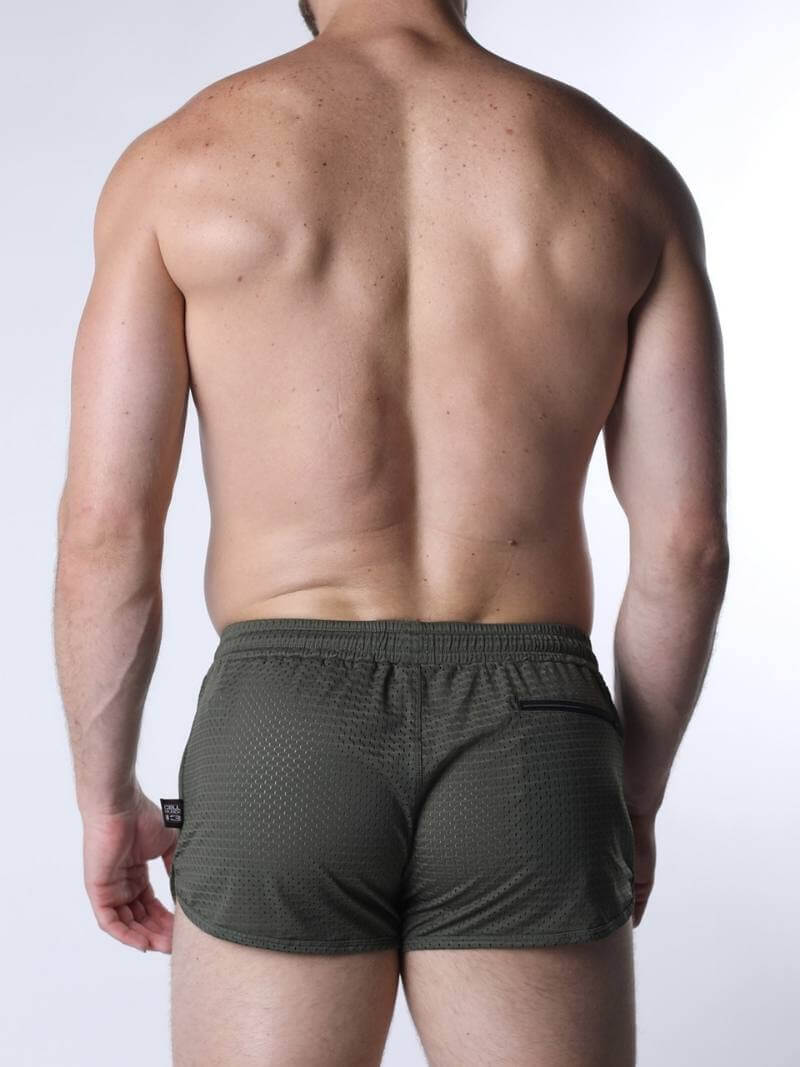 Man wearing green shorts on a white background