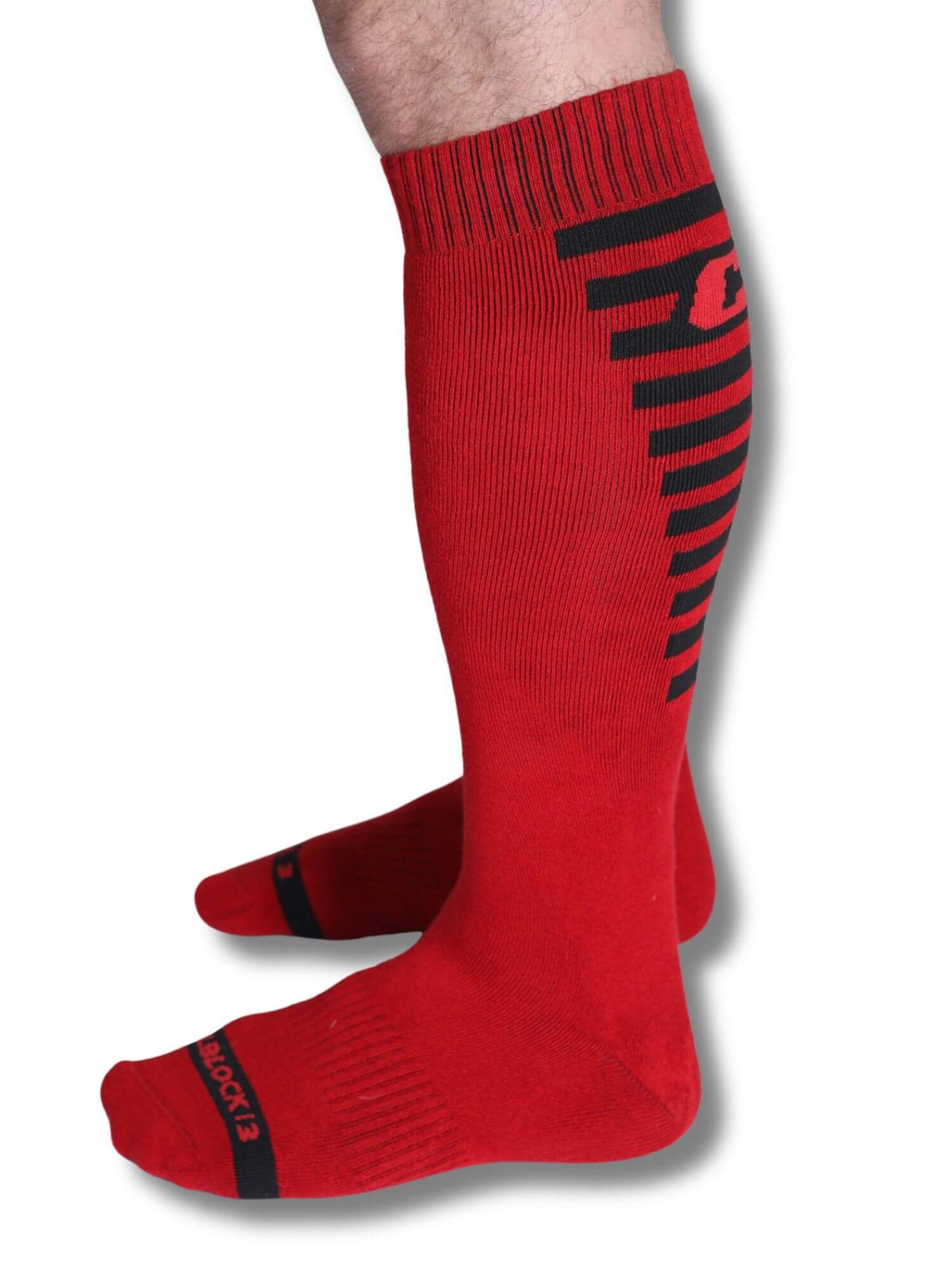 Red knee-high socks with black stripes on a white background
