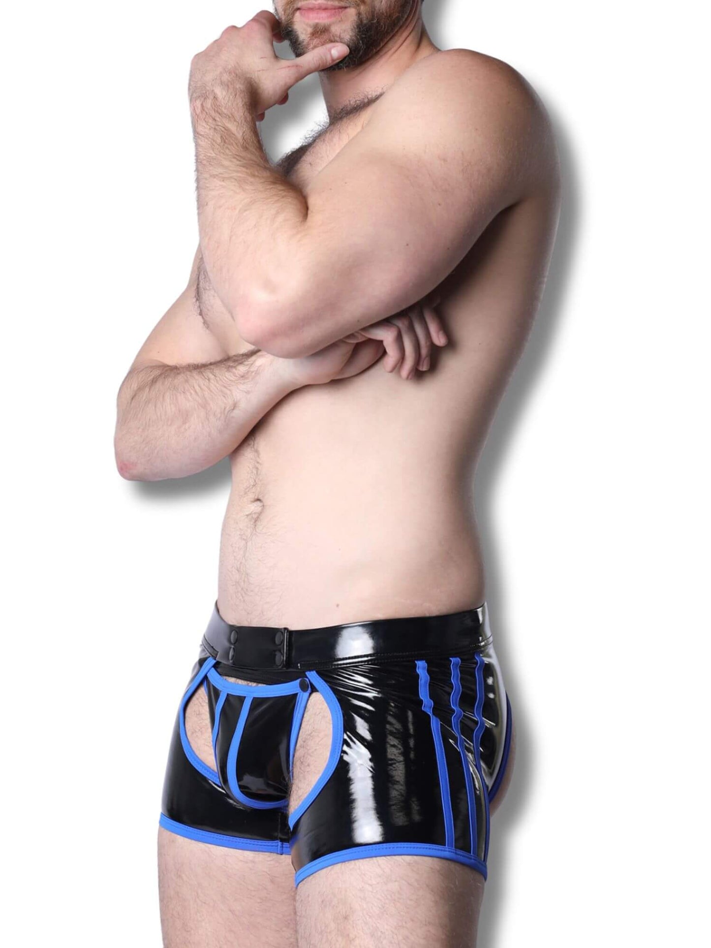 Man wearing black and blue latex underwear against a white background