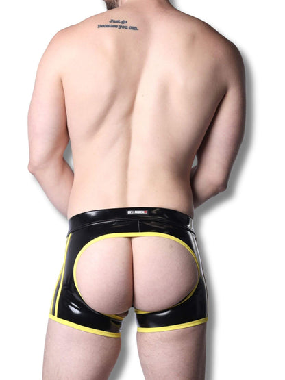 Man wearing black and yellow latex underwear on a white background