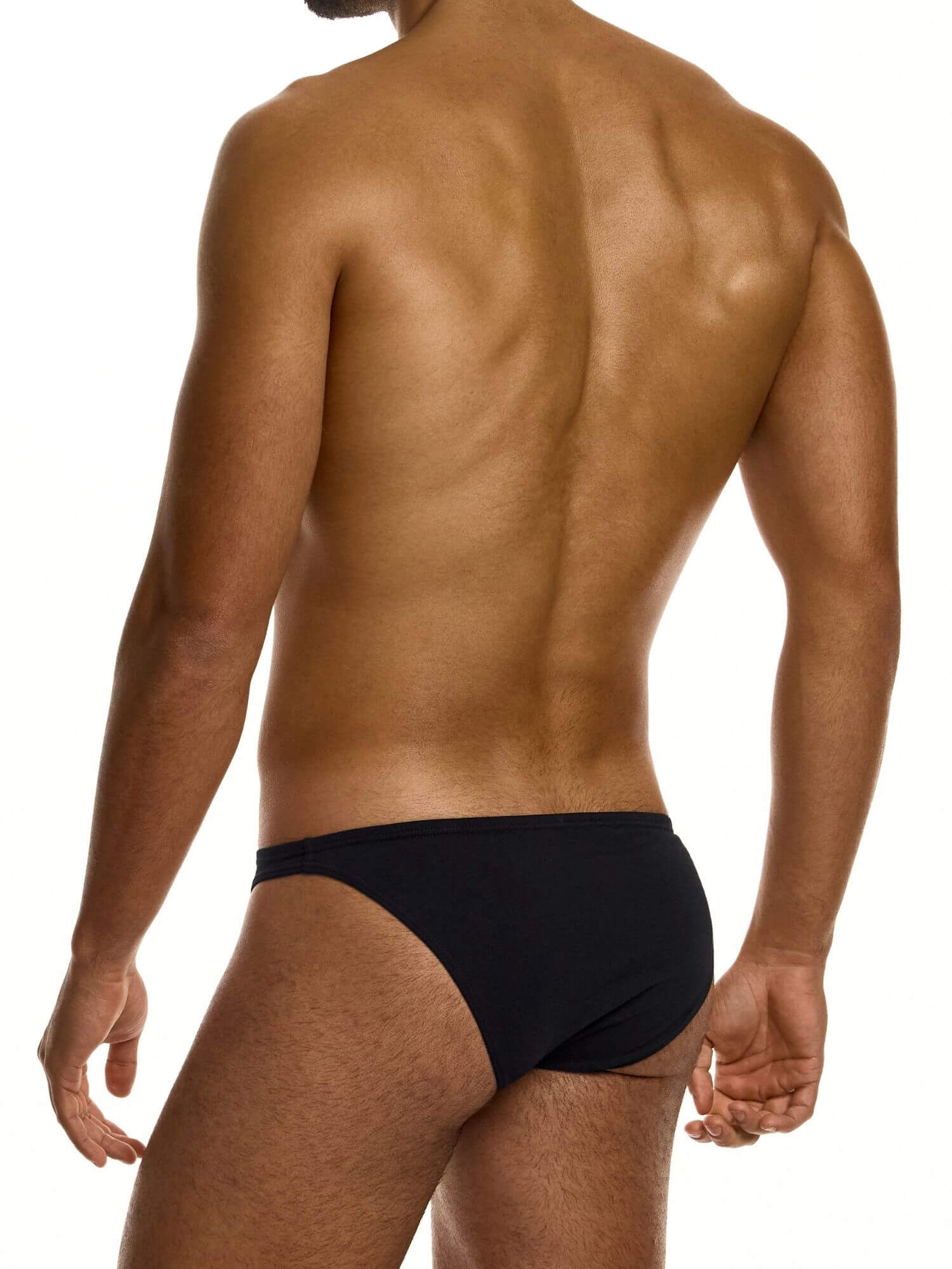 Man wearing a black low cut brief on a white background