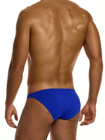 Man wearing a blue super low rise brief on a white background