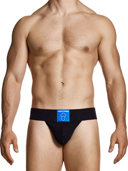 Man wearing a black men's underwear thong with a visible brand logo on a white background