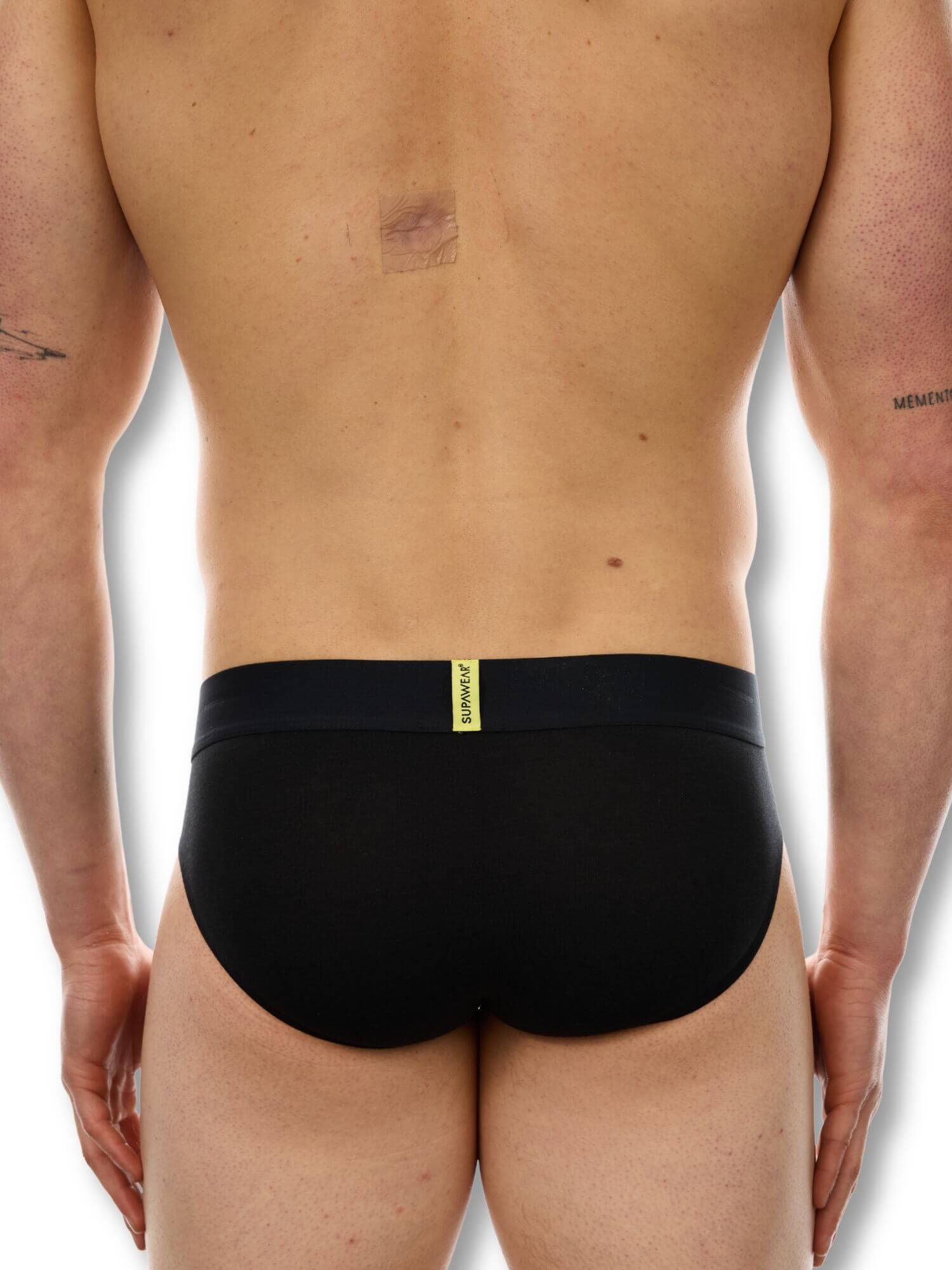 Black underwear worn by a person on a white background