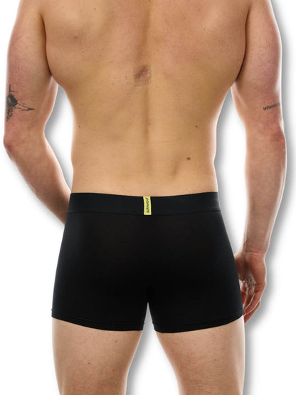 Black boxer briefs worn by a person on a white background