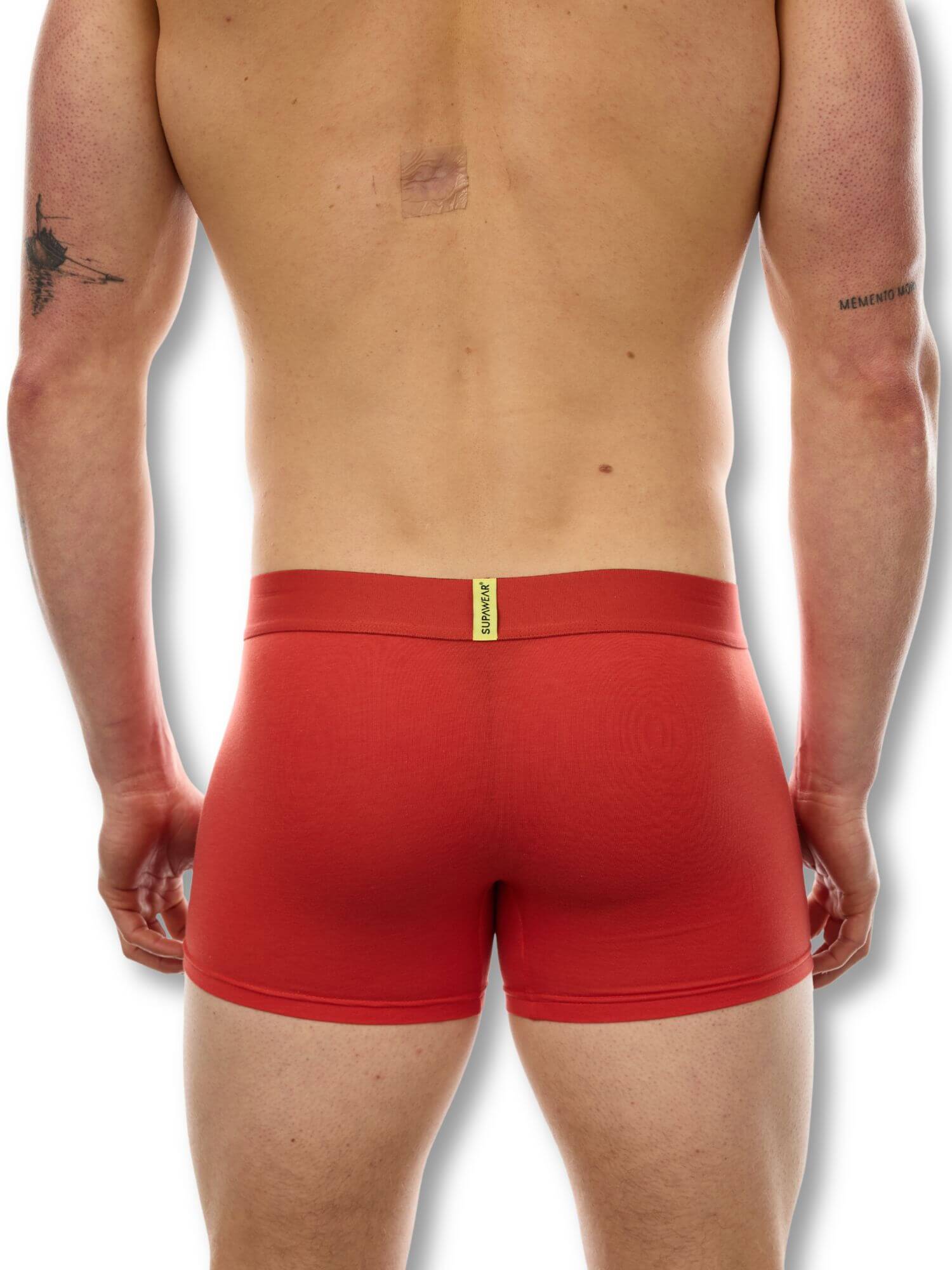 Red boxer briefs worn by a person on a white background